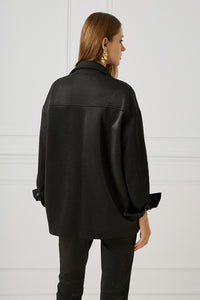 Woman wearing iRous "Winter" oversize σακάκι with fishbone black shiny print and unique embroidery, back view.